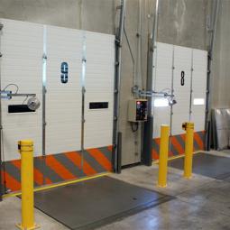 Bollards protecting garage doors in a receving area.